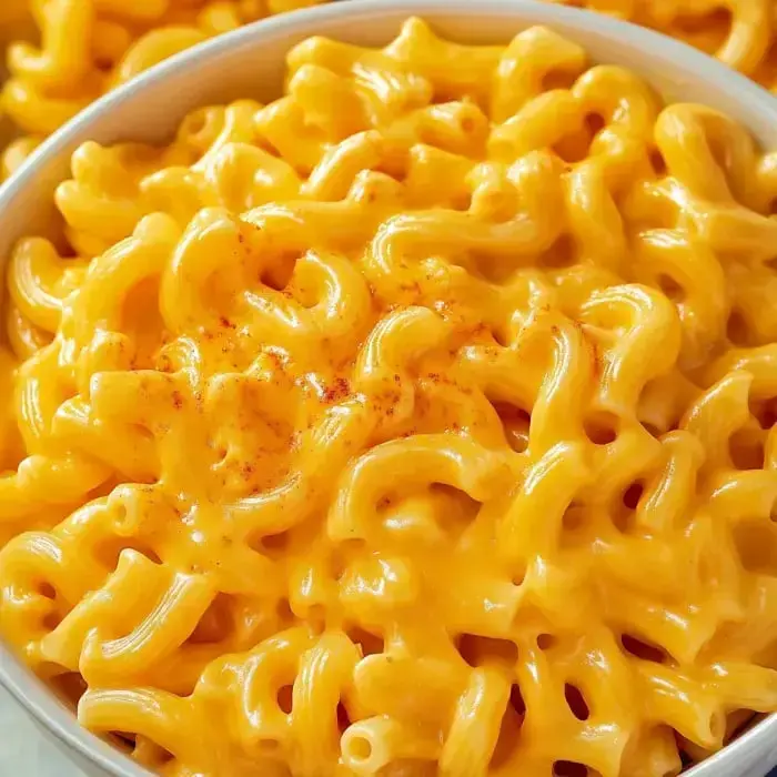 Close-up of creamy, cheesy macaroni topped with paprika.