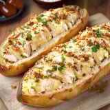 Golden loaves filled with chicken, bacon, gooey cheese, and herbs. All set on a wooden board.
